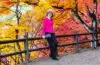 A stylish mature woman poses in front of vibrant autumn maple trees in Korankei Park, Aichi, Japan. | โครันเค (Korankei / 香嵐渓)