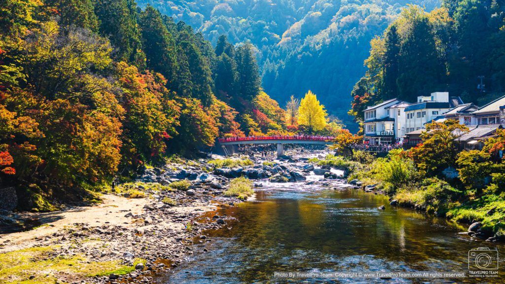 Colorful autumn foliage and the iconic Taigetsukyo Bridge over Tomoe River in Korankei Gorge, Toyota, Aichi Prefecture, Japan